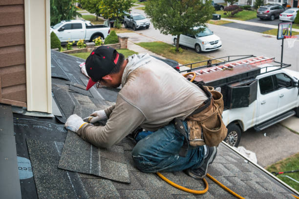 Professional Roofing technician working in Cove, OR